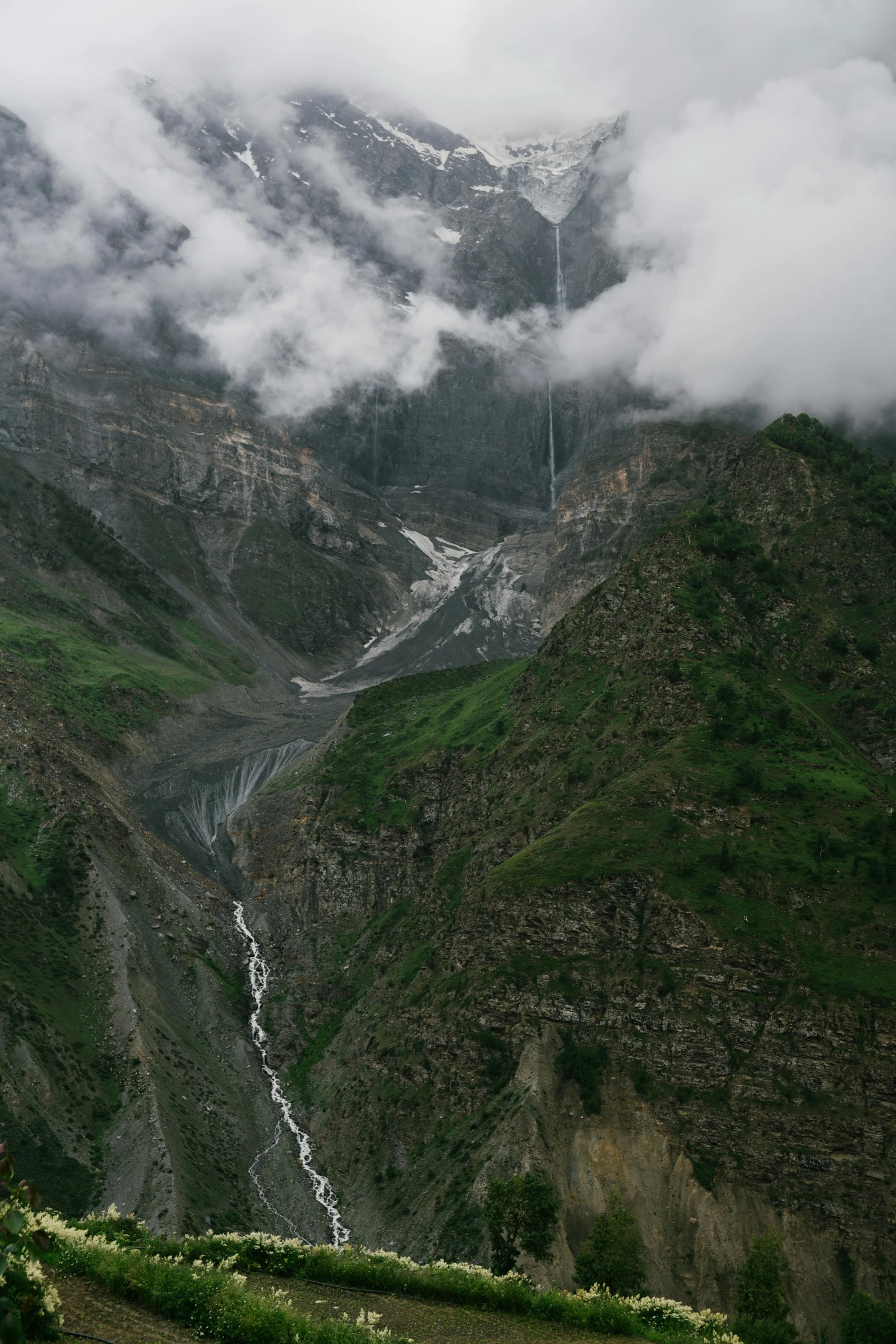 a mountain with mist covering the valleys