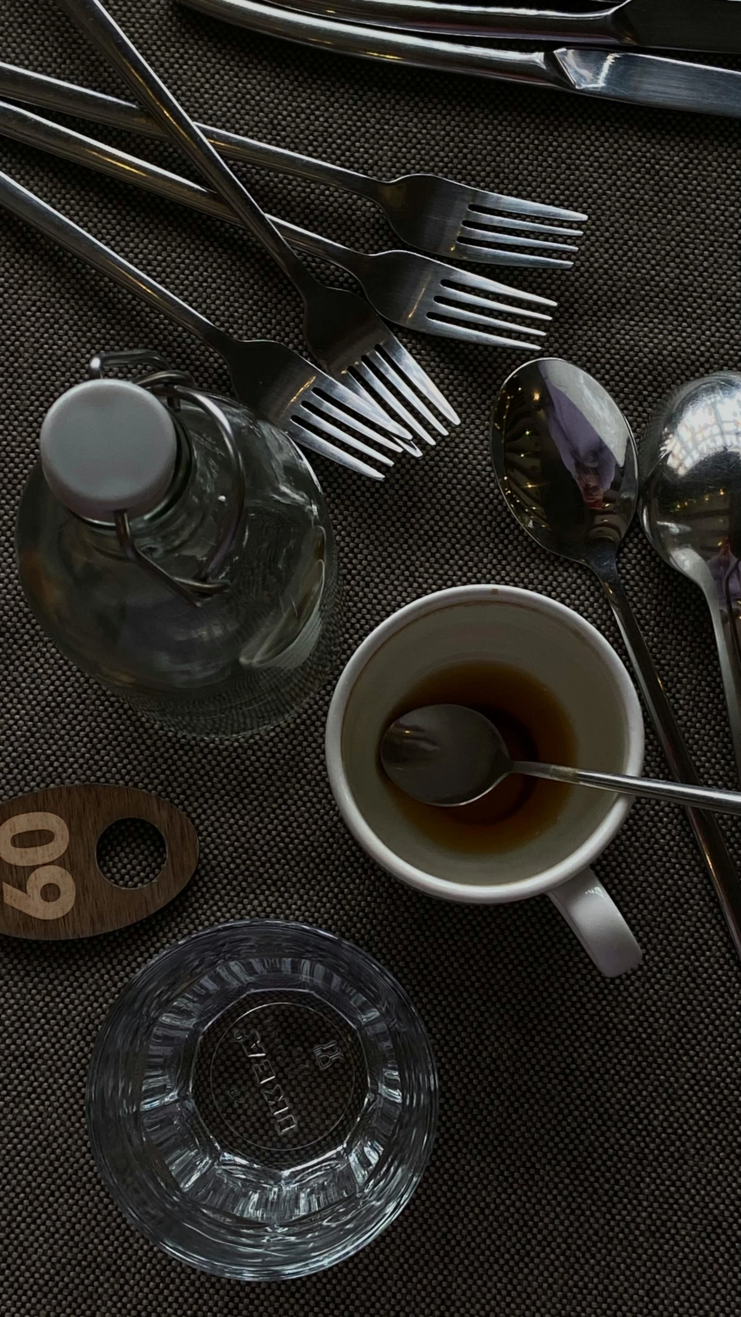 various silverware and spoons are spread out on the table