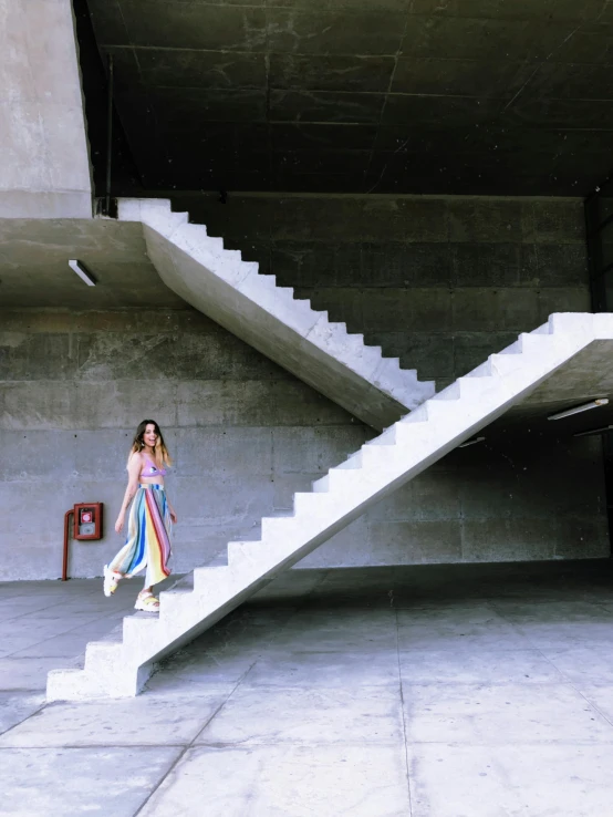 girl walking up some steps with a backpack on her back