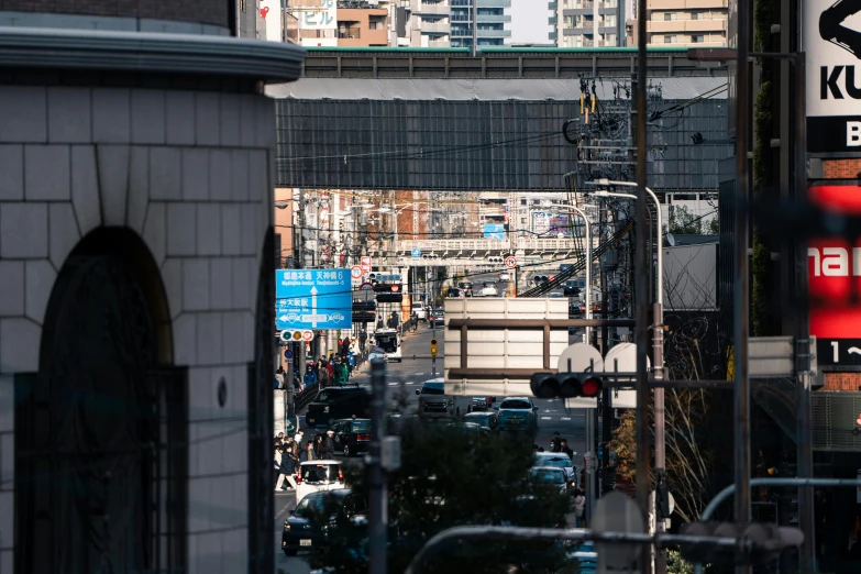 the city has numerous cars and pedestrians traveling through the busy streets