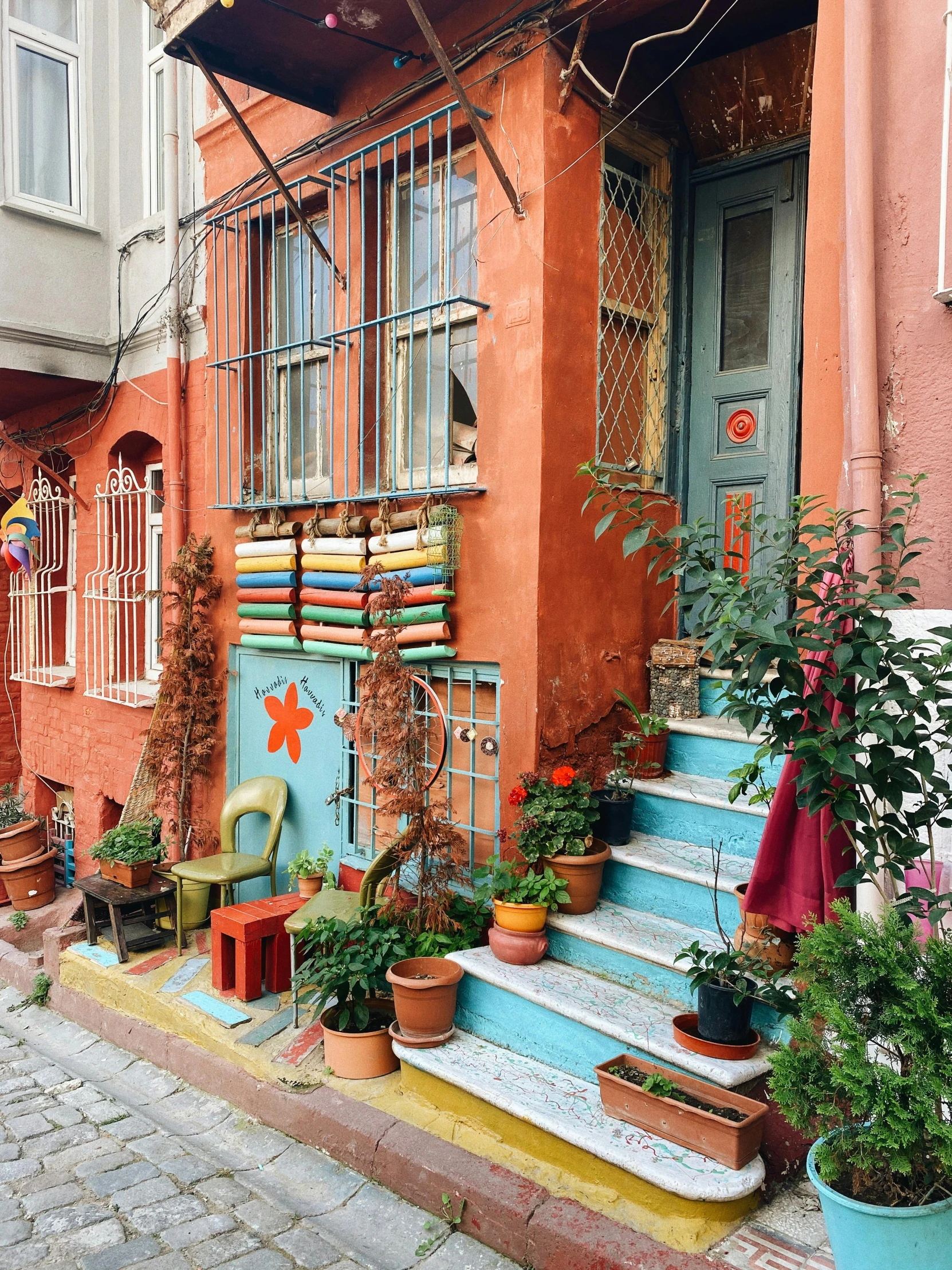 a building with potted plants on the doorstep and a doorway