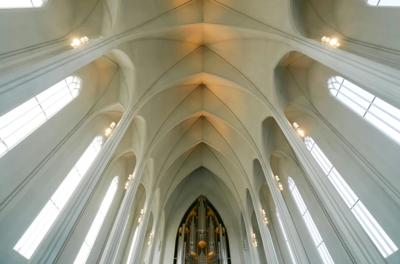 an aisle with high ceiling in the middle of a church