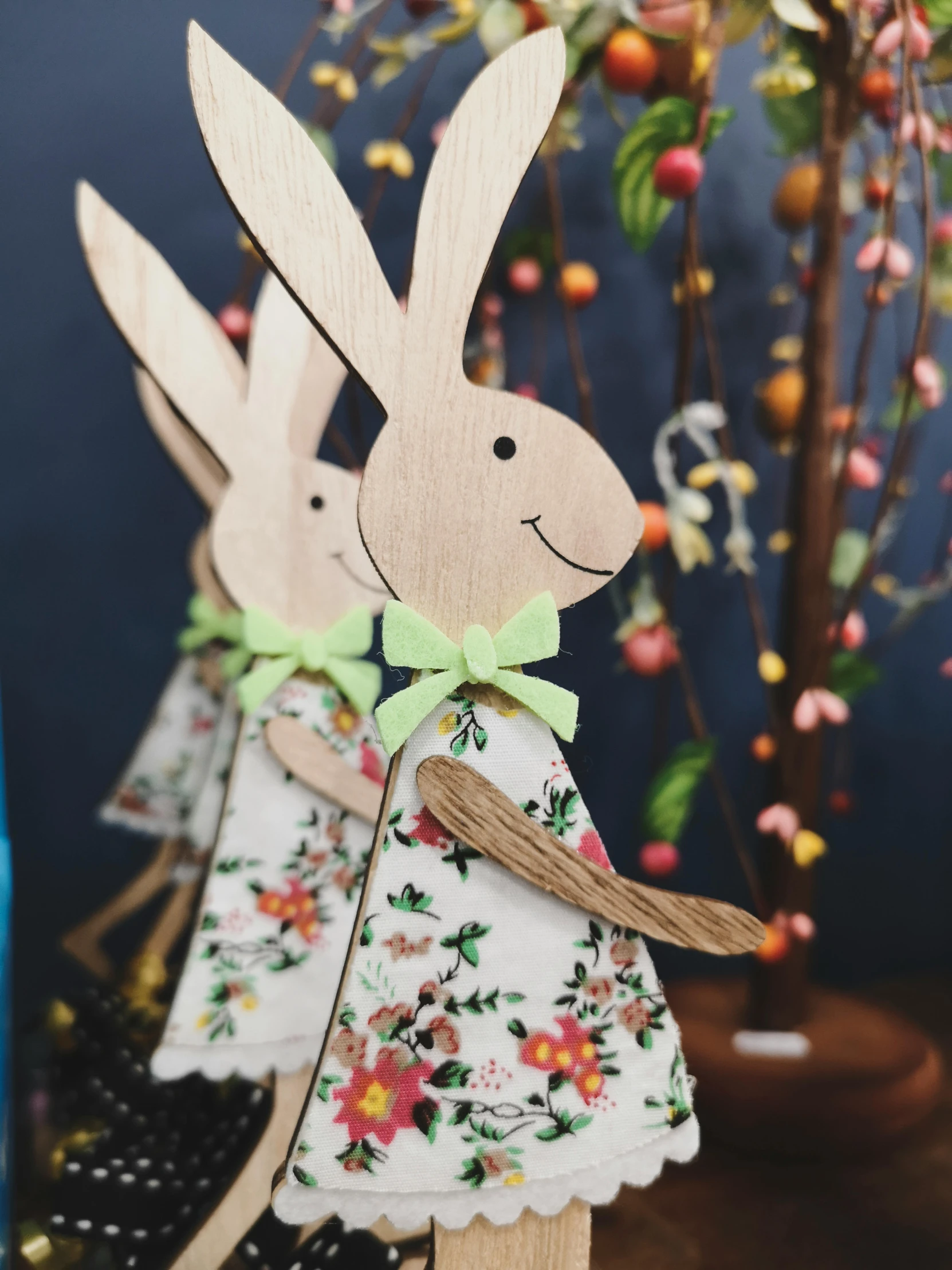 a picture of paper easter bunnies dressed in floral clothing and green bow tie