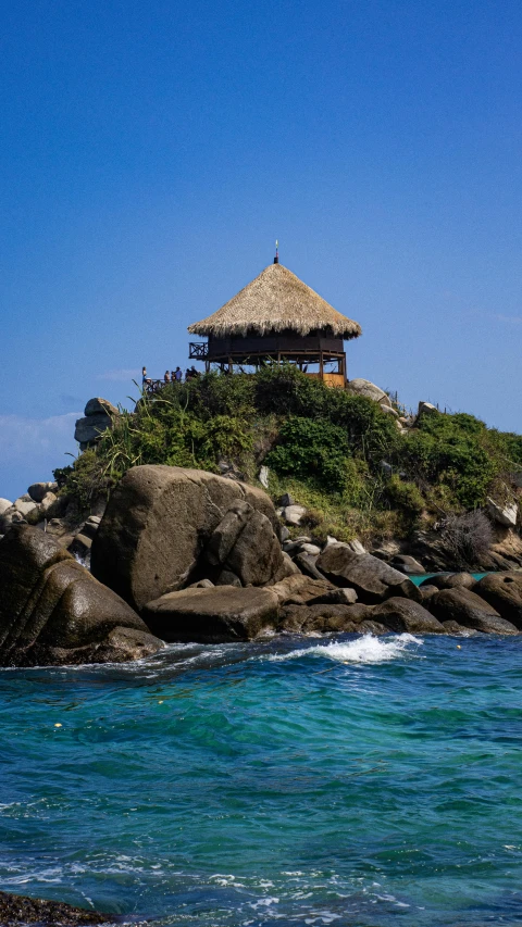 an island in the middle of the ocean with lots of rocks on it