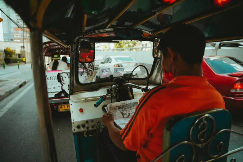 man at the controls of a white and blue bus