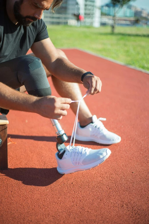 a man holding a tennis racquet over a tennis shoe