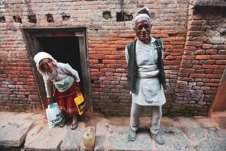 a man is in front of a doorway and another has two bags