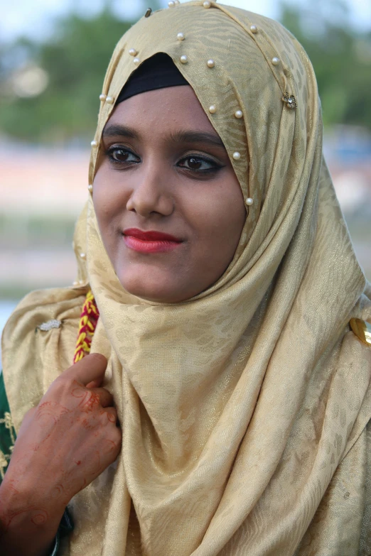 a woman in a headscarf is smiling