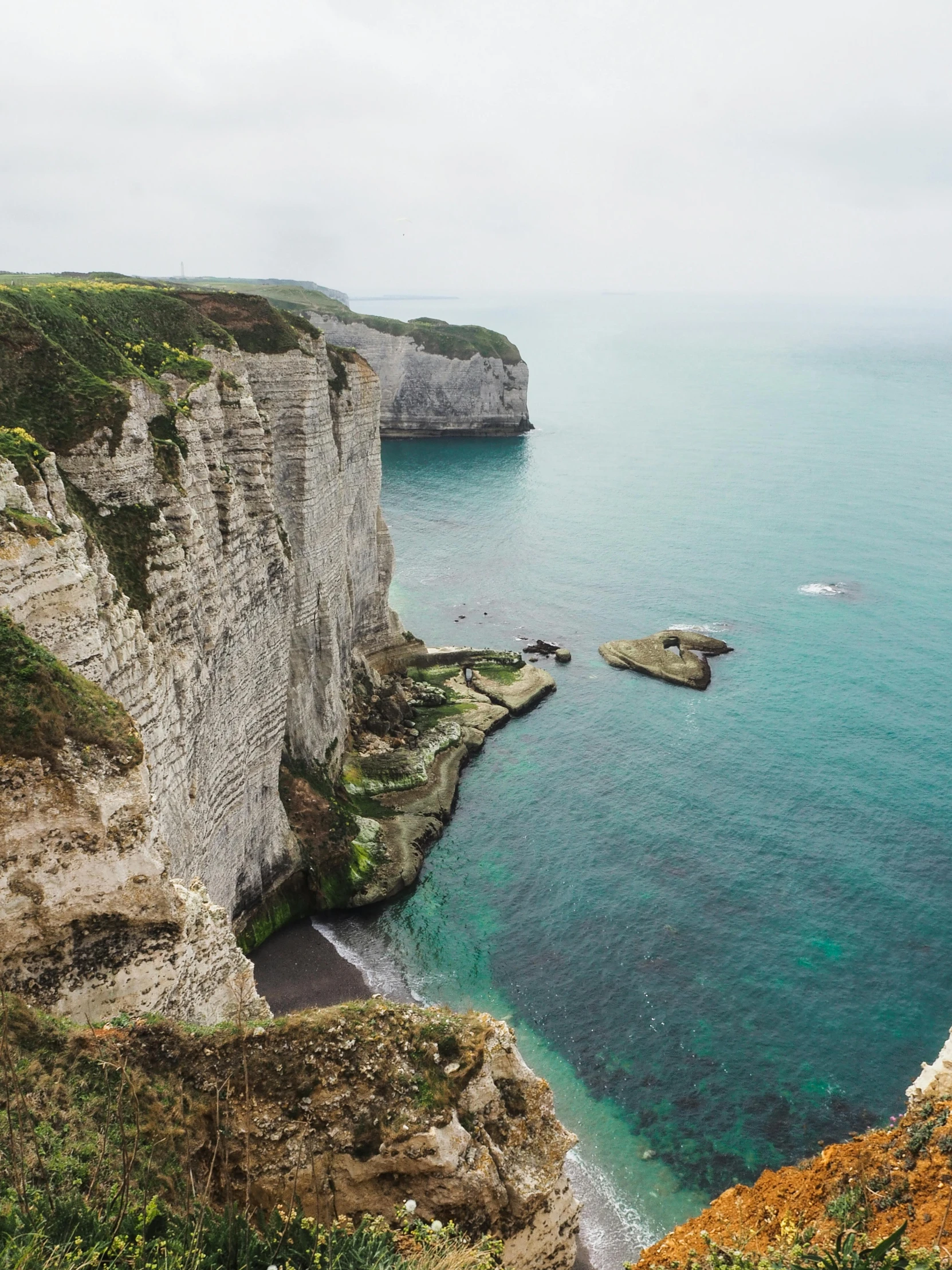 a view of a body of water with cliffs and cliffs in the distance