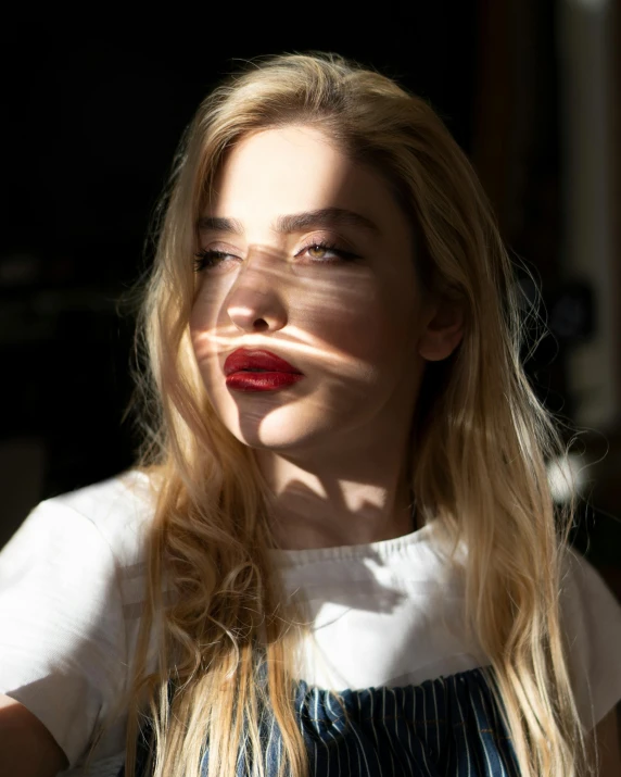 young blonde woman with red lips posing for picture