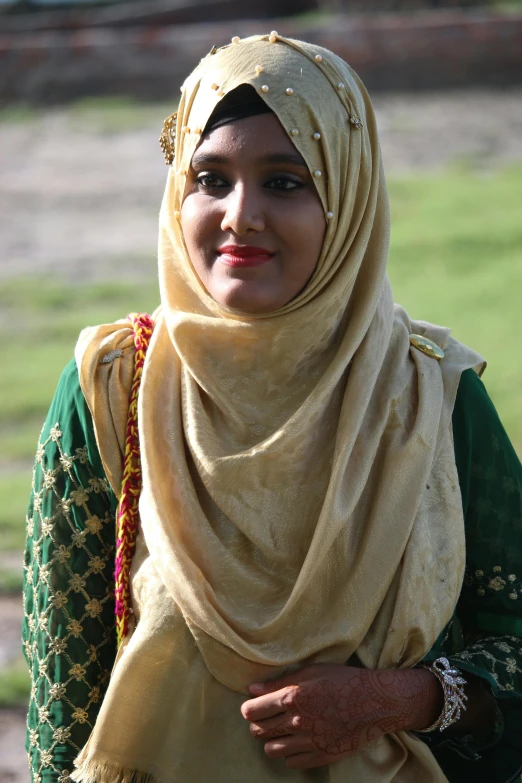 a woman in a headscarf smiling at the camera