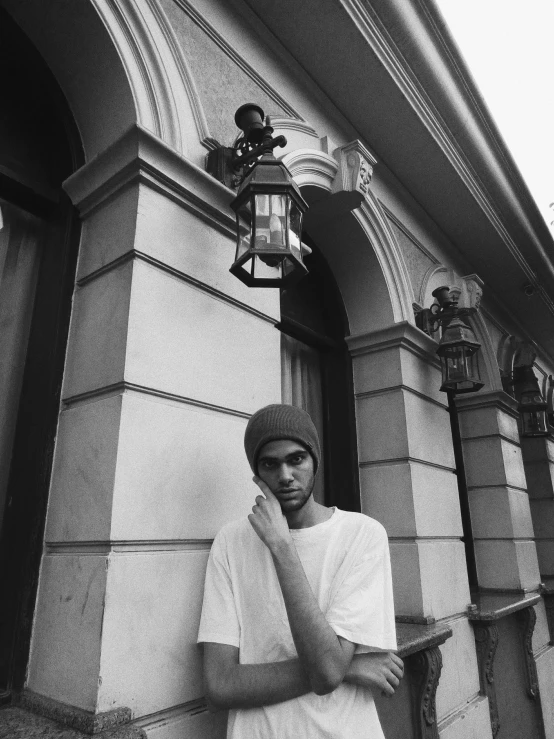 a person standing near a tall building with their cell phone