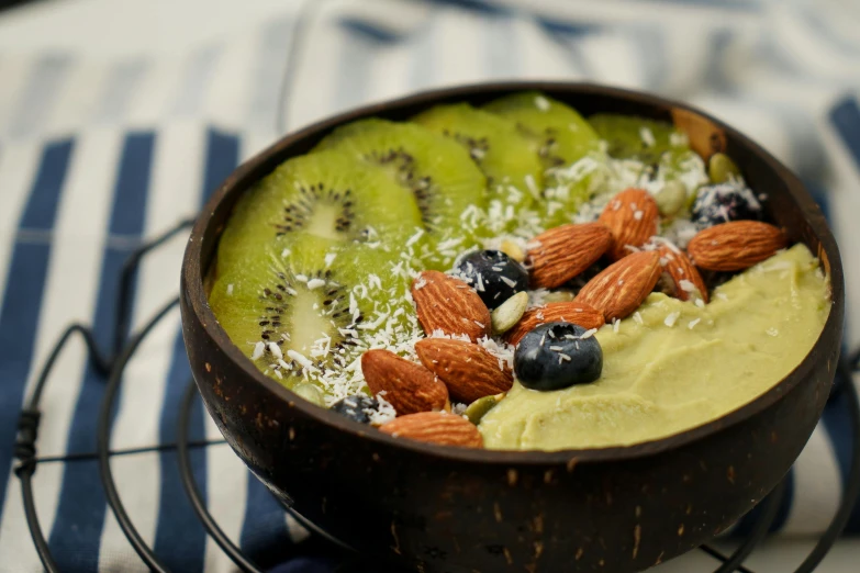 a food item sitting on a plate covered in nuts and fruit