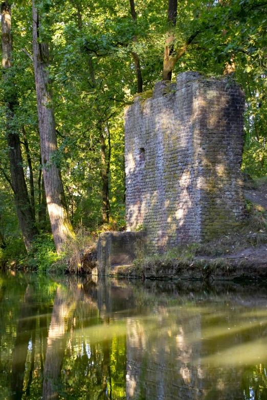 a lake sitting between trees and a rock formation