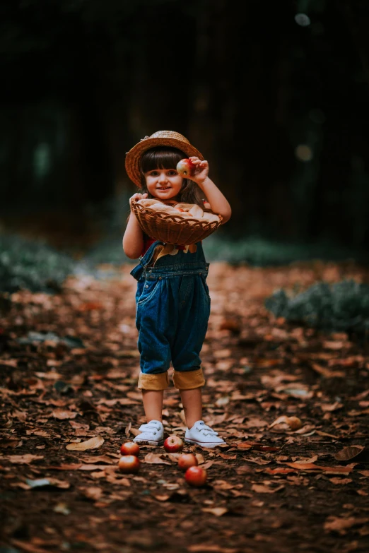 a small child with an apple and baseball mitt on