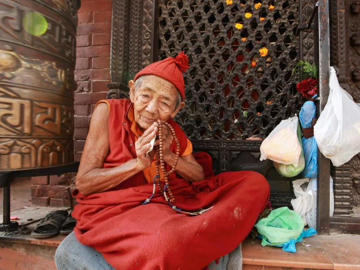 a very old man playing a pipe outside