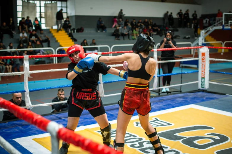 two people in a ring with a punching glove