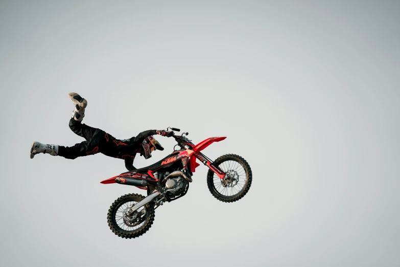 a person on a motorcycle performing a flip