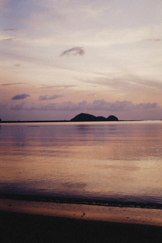 a cloudy day over the ocean with calm water