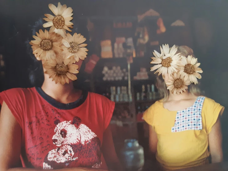 two women wearing flower crowns and posing for the camera