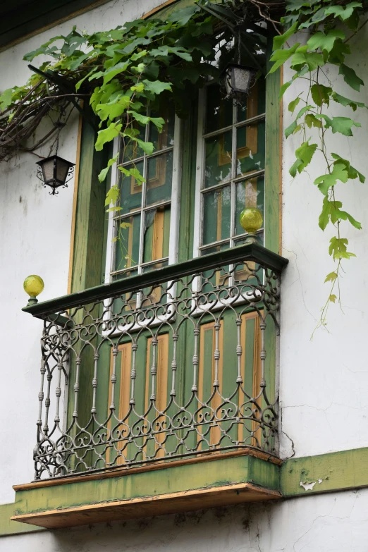 an open window with a balcone above it