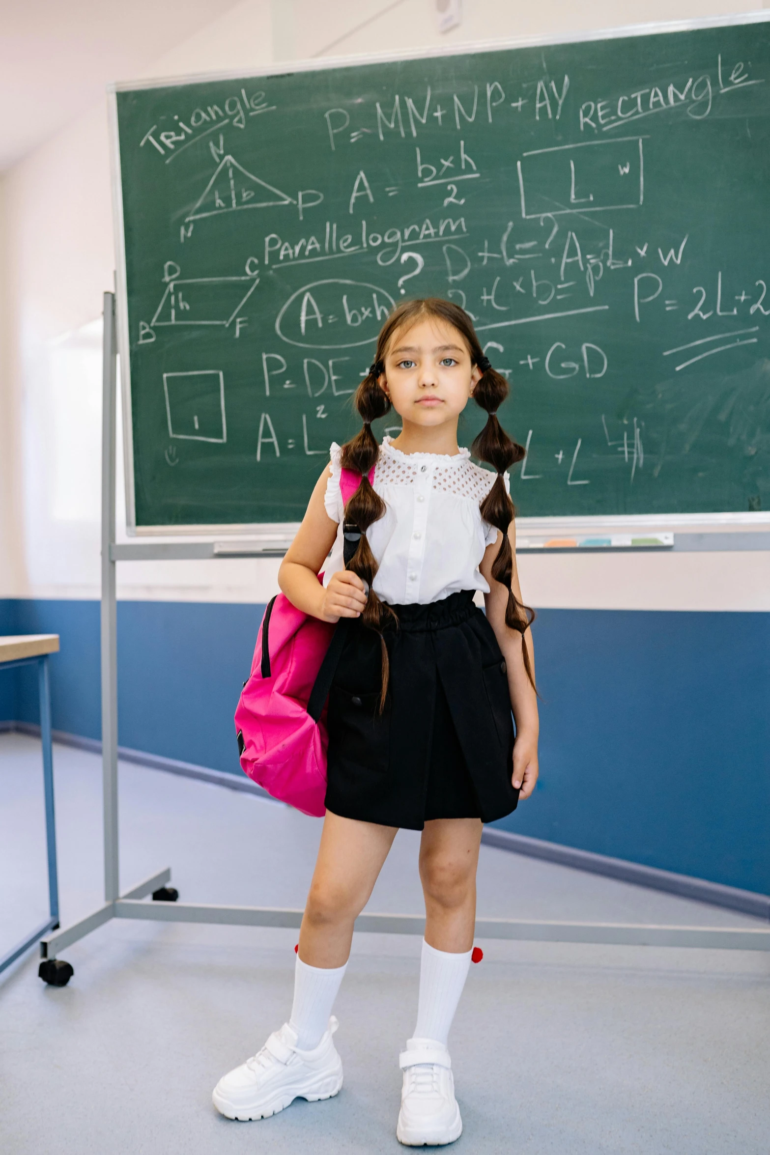 a  stands in front of a chalk board