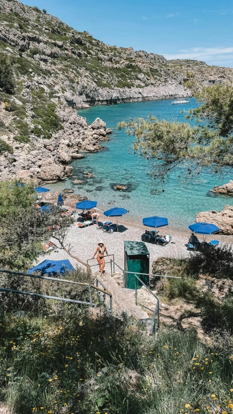 the sandy beach has umbrellas and chairs all over it