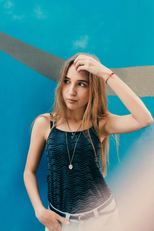 woman posing in front of a blue background