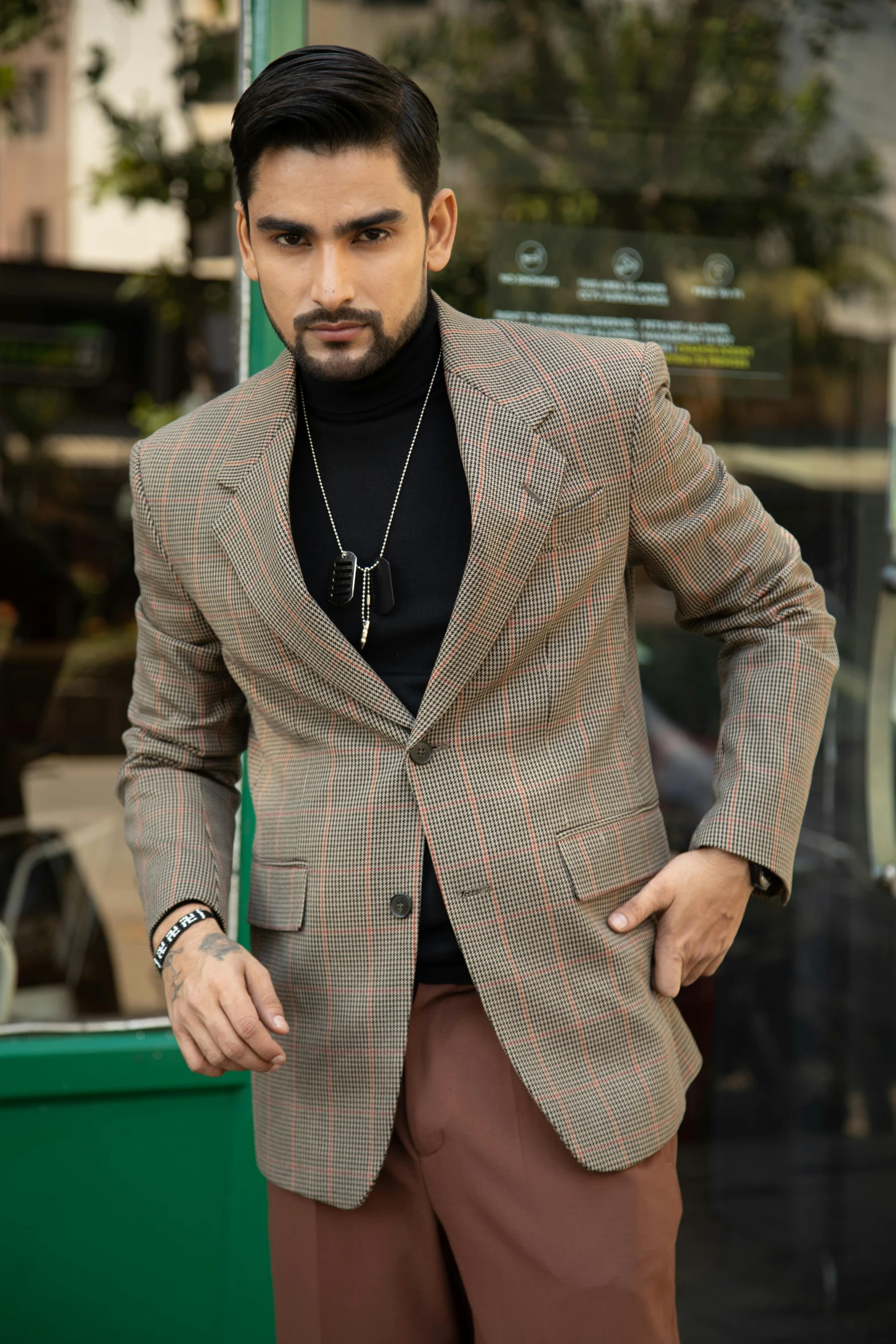 a man in a suit standing by a window