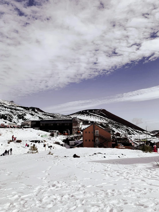 a man skiing down a hill on a windy day