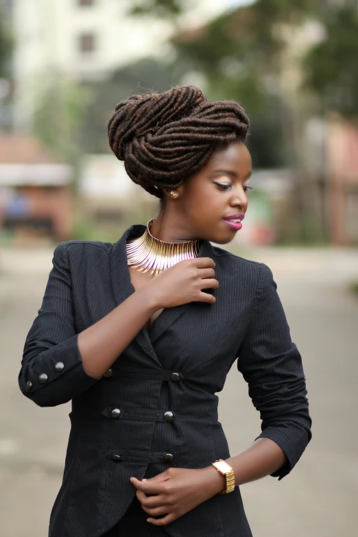 woman with ids wearing a black jacket and gold necklace