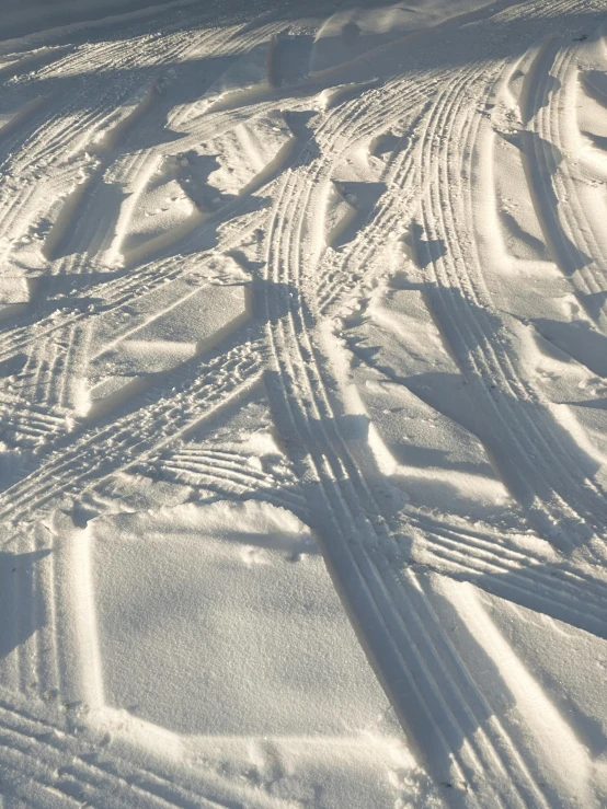 there is a snow covered tire trail in the winter