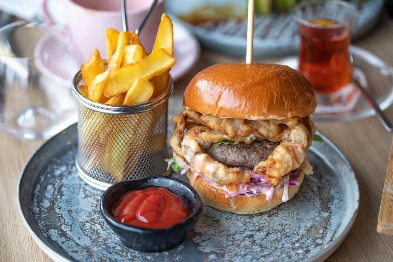 a close up of a plate with a burger and french fries