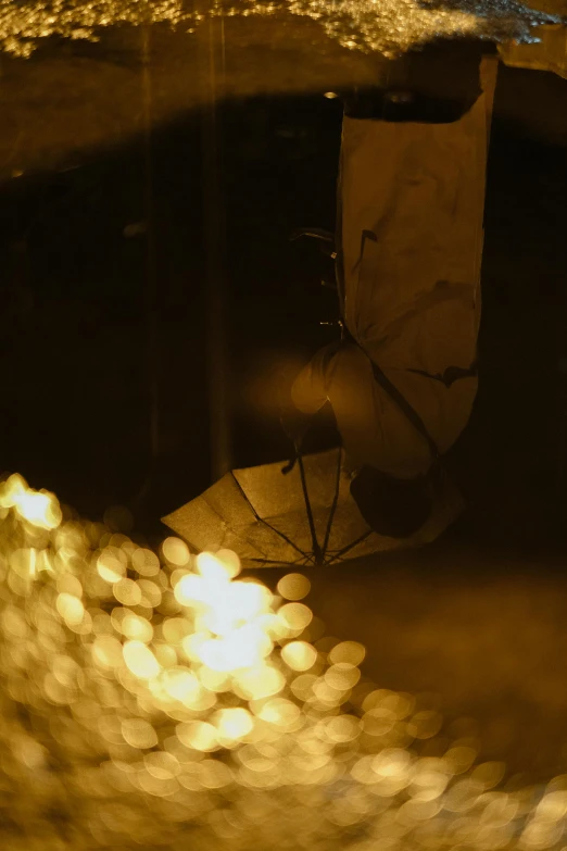 an umbrella sitting outside on the sidewalk at night