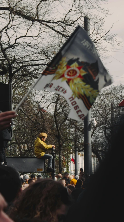 a man on the back of a vehicle with an upside down flag