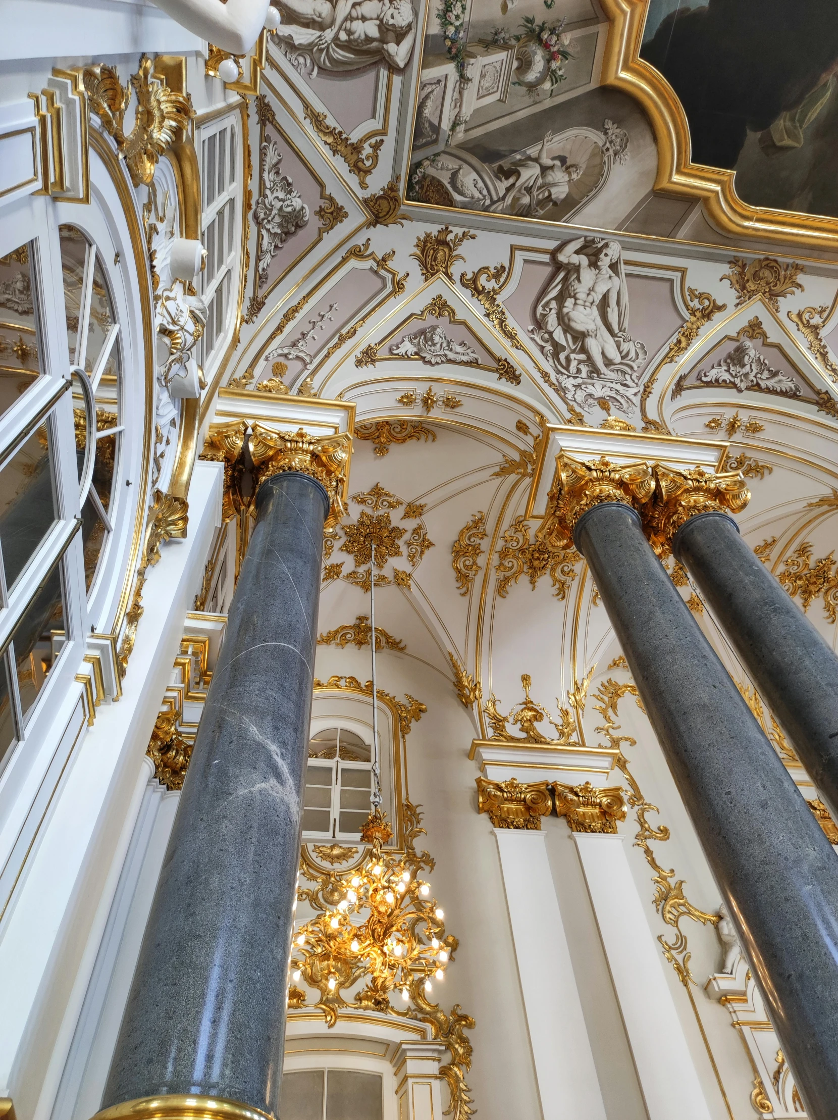 a cathedral ceiling with chandeliers and golden ornaments