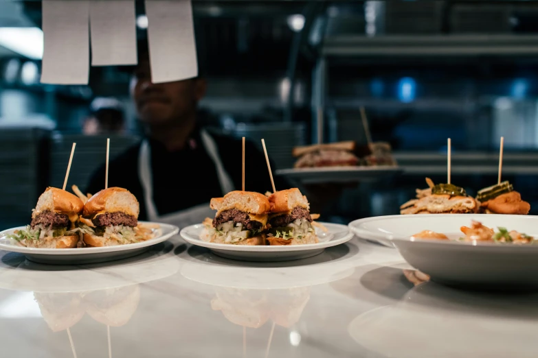 a plate with a sandwich and other foods on a counter