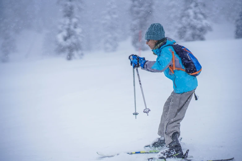 a child standing on skis holding his ski poles in the snow