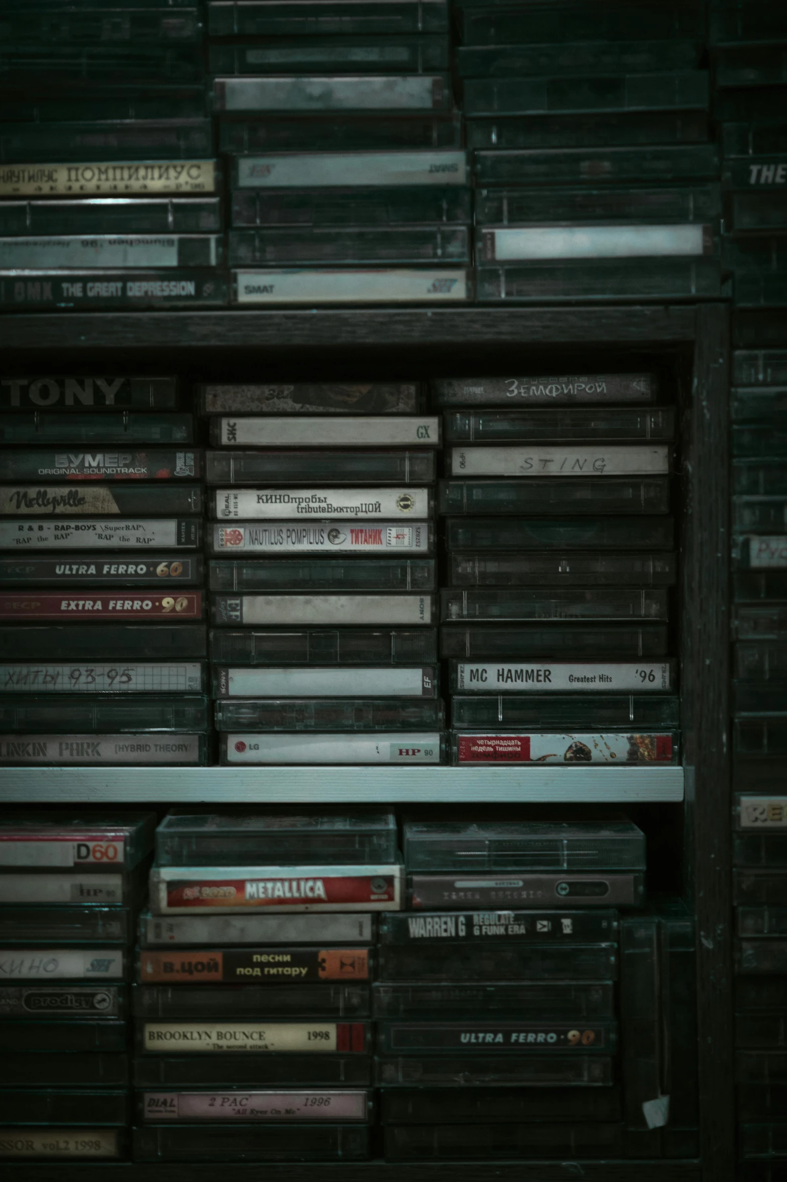 a bunch of cds are stacked on a shelf