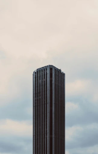 a large jetliner flying next to a tall building