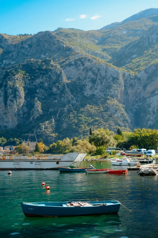 a small boat in the water near mountains