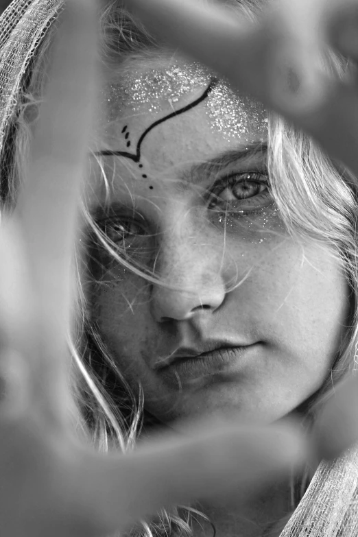 an image of a woman's face covered with the word love in her hand