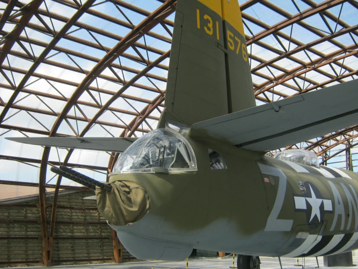 a large air plane under a metal structure