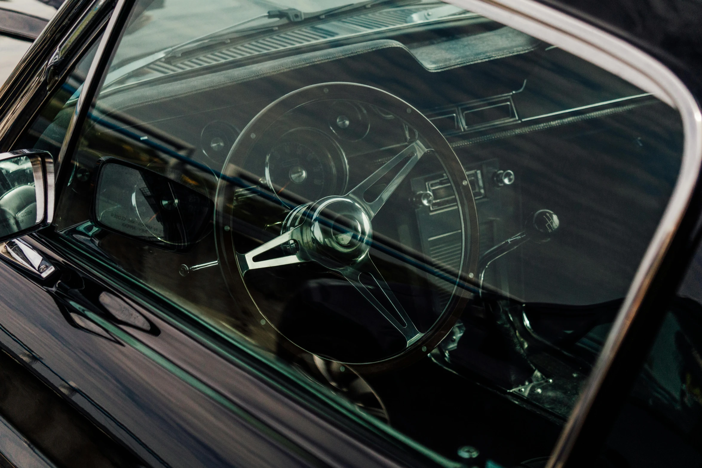 the inside view of a classic car, looking from the dashboard