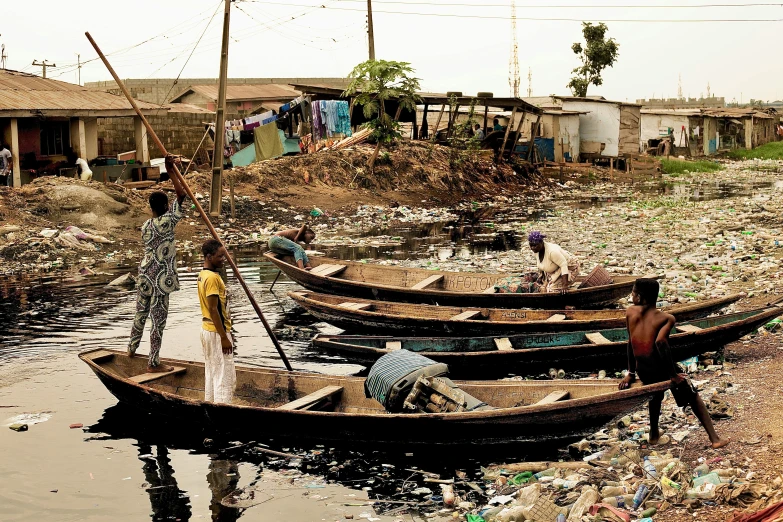 a couple of boats floating in a river next to houses