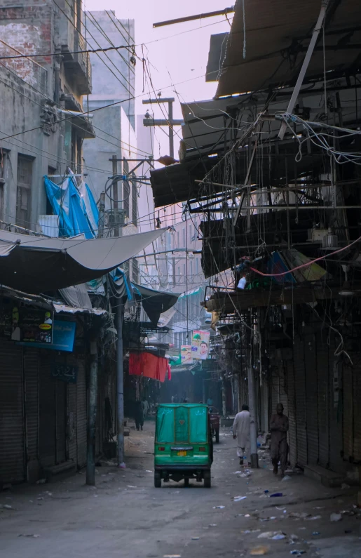 people are walking on an old city street