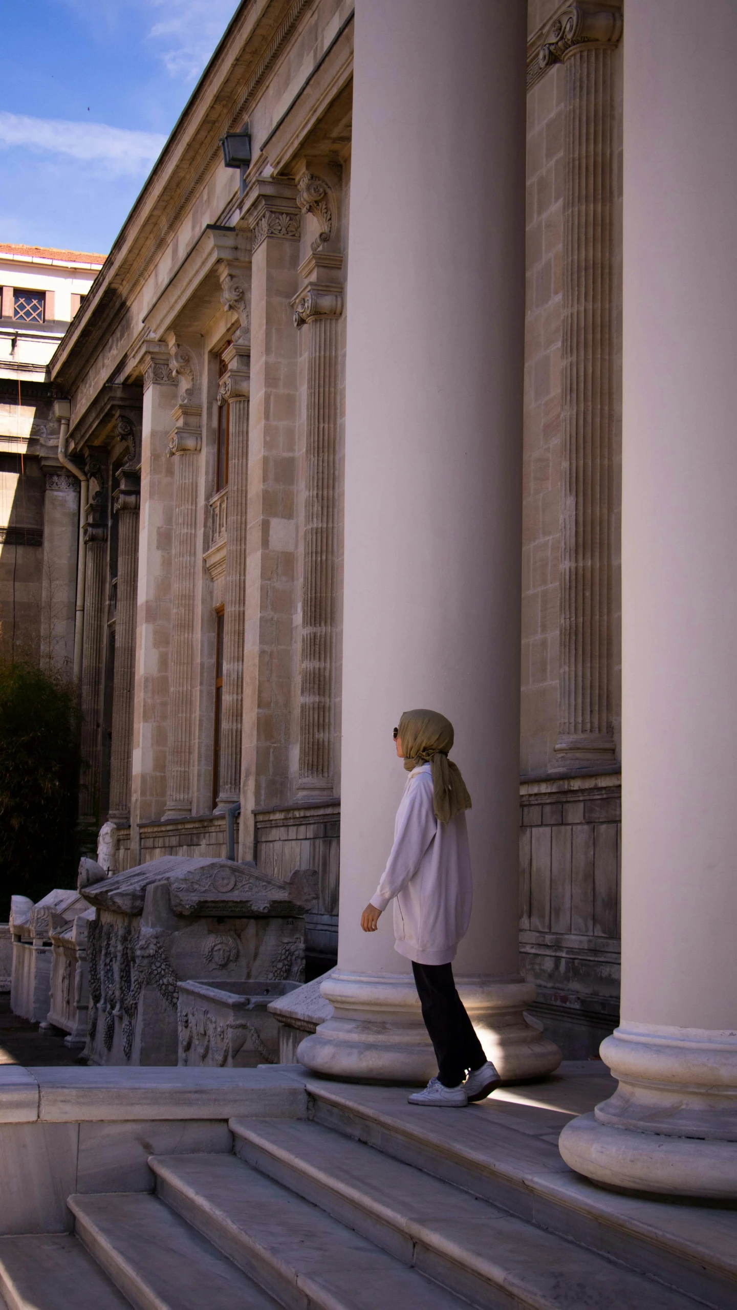 the woman is walking on steps to a building