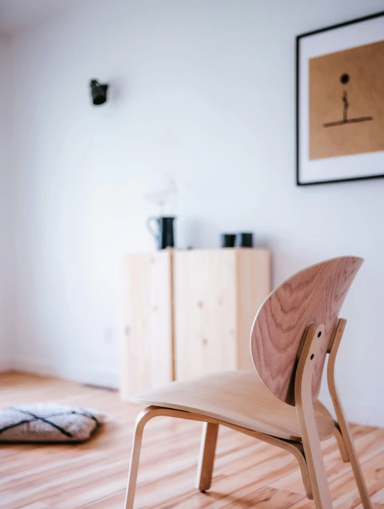 a wooden chair in a room with wood floors