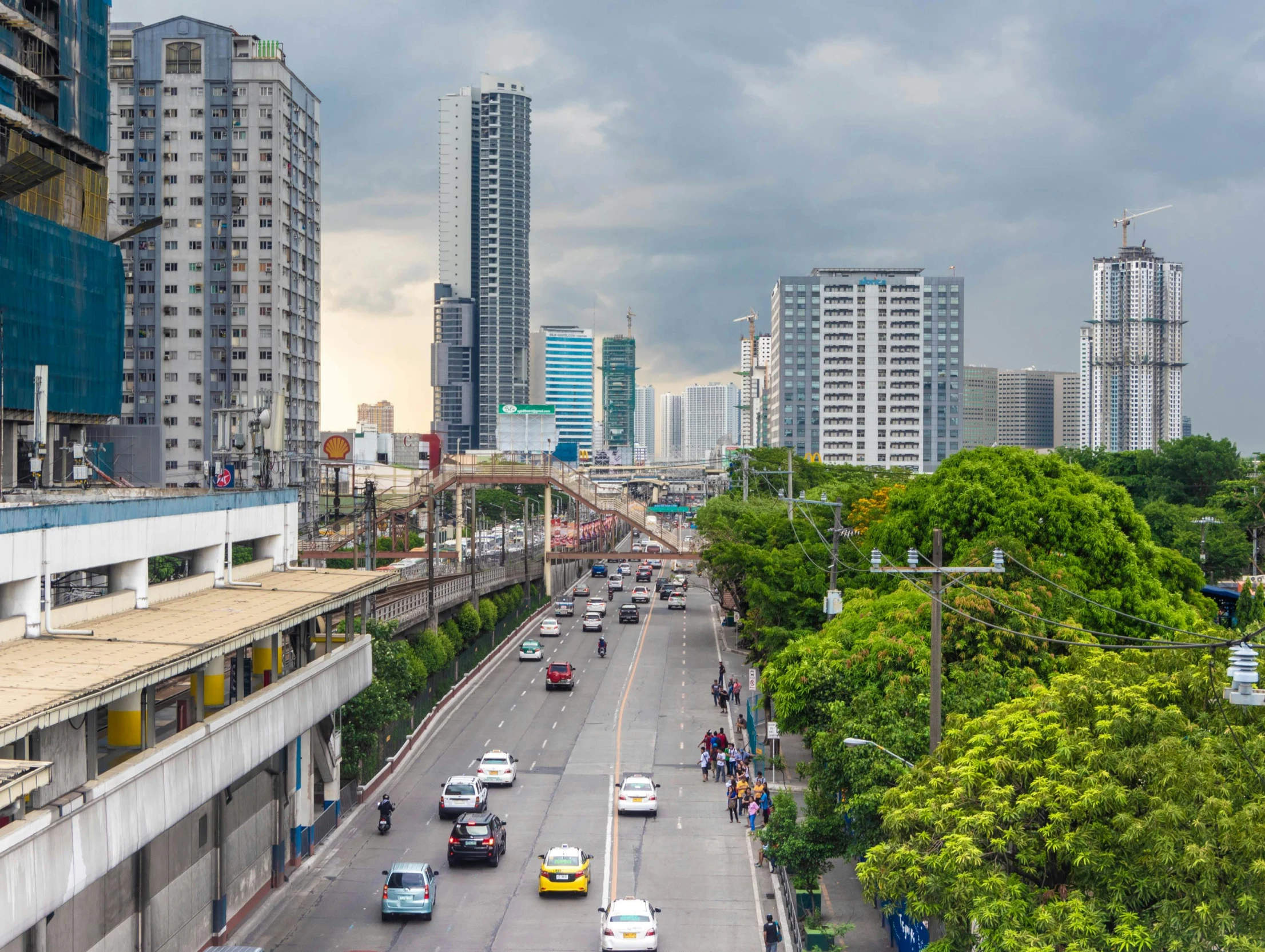 cars and vehicles travel down an urban road