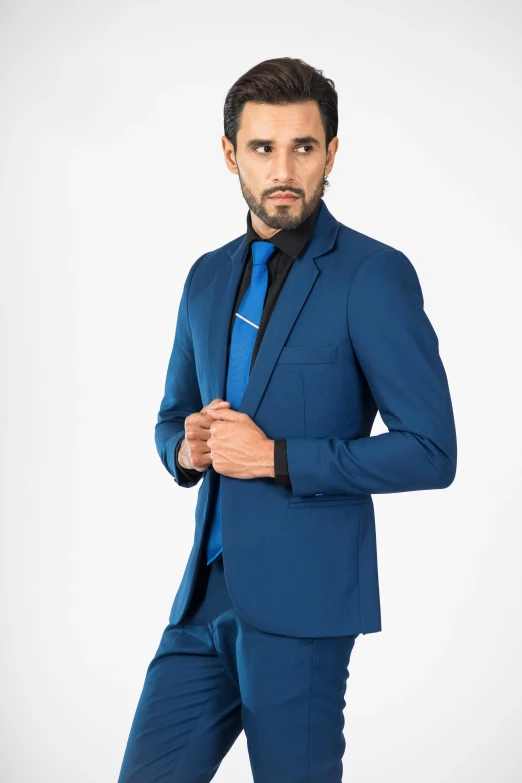 a man is dressed in a blue suit